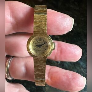 Gold watch in perfect condition.